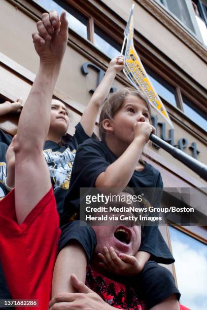 Boston, Mass. -- Dave Vazquez and his daughters Jacinda on shoulders, and Brianna cheer on the Bruins during the team's Stanley Cup celebration...