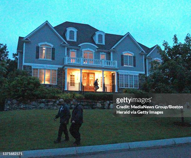 State Police mill about the home of ex New England Patriots tight end Aaron Hernandez after a rental car, rented in Hernandez's name was possibly...