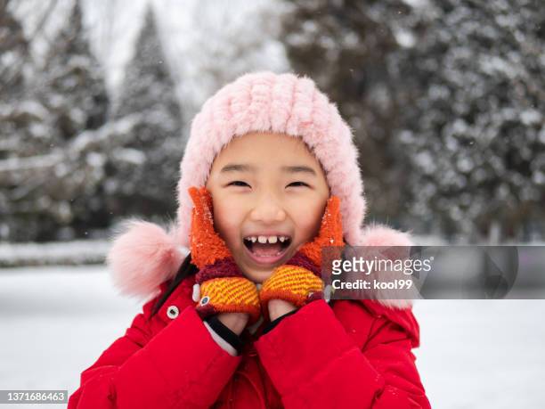 little girl playing snow - child winter coat stock pictures, royalty-free photos & images
