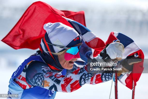 Therese Johaug of Team Norway celebrates winning gold during the Women's Cross-Country Skiing 30k Mass Start Free on Day 16 of the Beijing 2022...