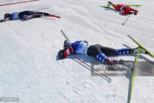 Tiril Udnes Weng of Team Norway, Cendrine Browne of Team Canada and Novie McCabe of Team United States al collapse after crossing the finish line...