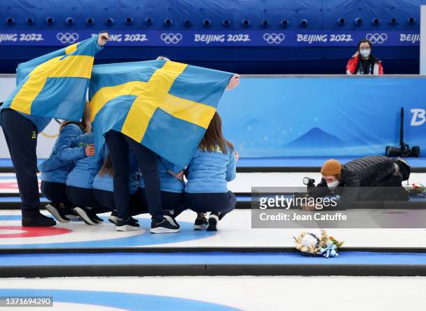 Bronze medallist Team Sweden pose for photographers following the medal ceremony of the Women's Gold Medal match between Team Japan and Team Great...