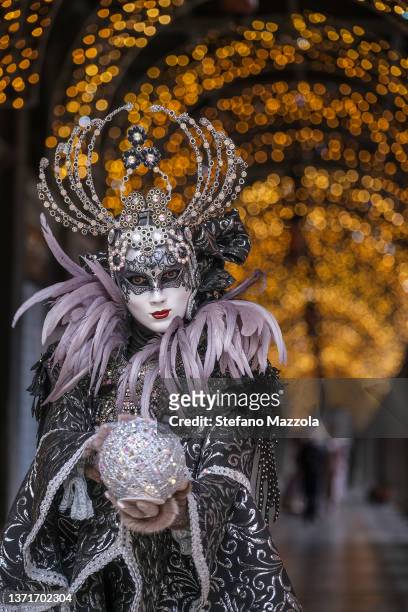 Masked revellers pose in St Mark's Square on February 20, 2022 in Venice, Italy. The theme for the 2022 edition of Venice Carnival is 'Remember the...