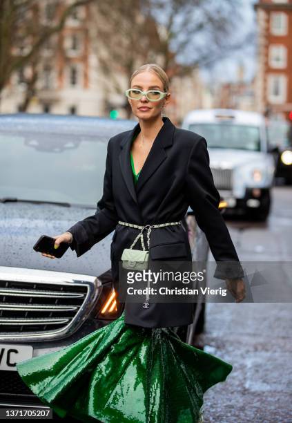 Leonie Hanne seen wearing green dress, Chanel micro belt bag, black blazer, sunglasses, laced heels outside Huishan Zhang during London Fashion Week...