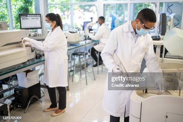 group of scientists working in the laboratory - forensic science stock pictures, royalty-free photos & images