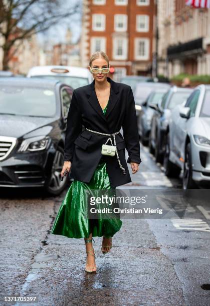 Leonie Hanne seen wearing green dress, Chanel micro belt bag, black blazer, sunglasses, laced heels outside Huishan Zhang during London Fashion Week...