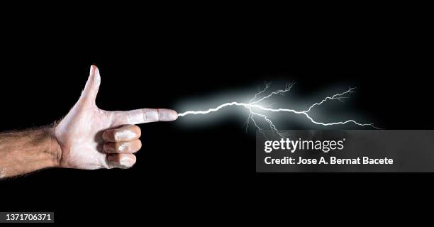 hand of a man simulating an electrical shot with lightning. - forked lightning stock pictures, royalty-free photos & images