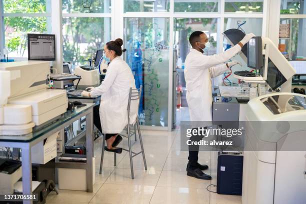 medical workers working in a patholoy laboratory - medical laboratory stock pictures, royalty-free photos & images