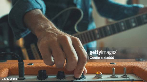 rock guitarist playing guitar at home - rehearsal studio stock pictures, royalty-free photos & images