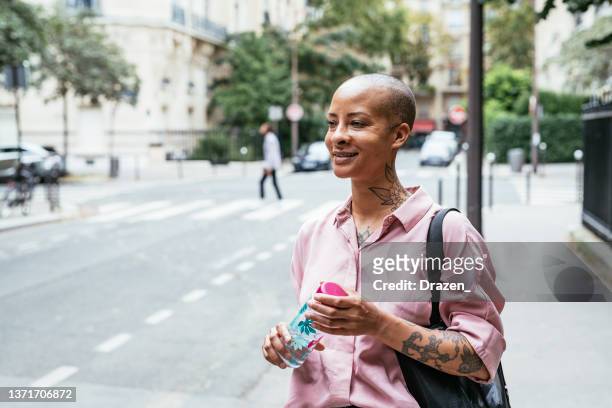 portrait of modern mixed race woman in the city - sassy paris stock pictures, royalty-free photos & images