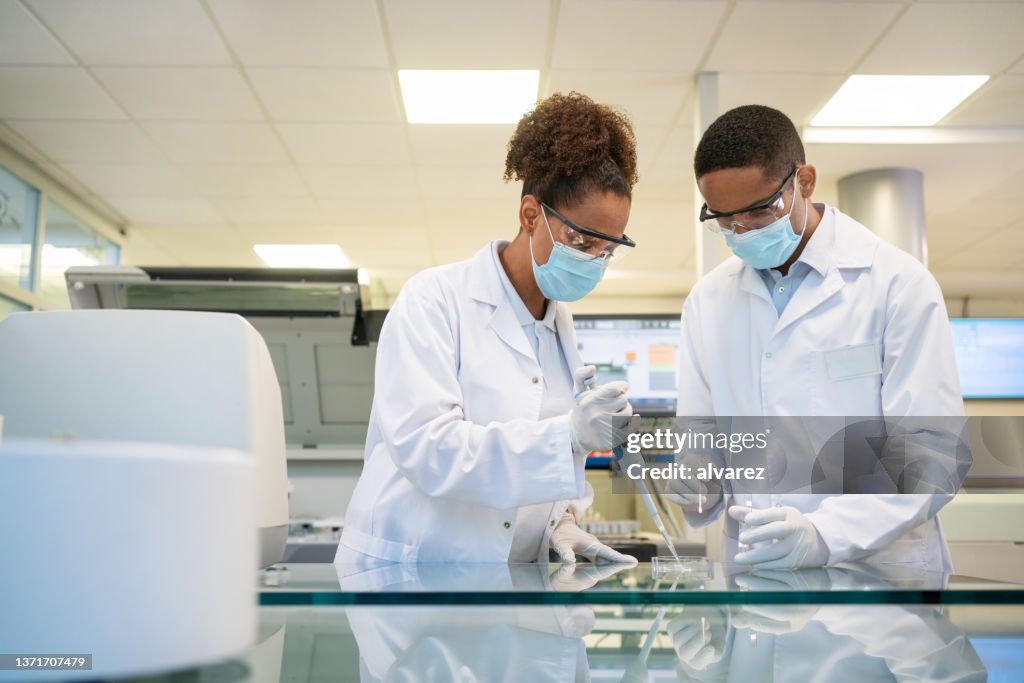 Two scientist conducting an experiment in laboratory