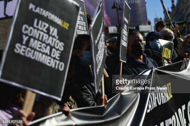 Several people, with banners reading 'Luz Ya', demonstrate to demand electricity contracts for La Cañada Real, at Puerta Del Sol, on 20 February,...