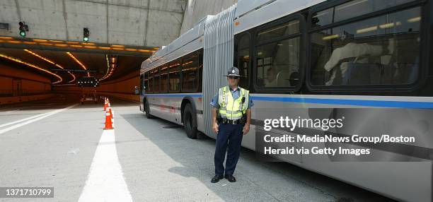 State Police Sergeant Mark Horgan watches busses filing through the Ted Williams Tunnel eastbound. .