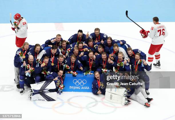 Members of Gold medallist Team Finland pose during the Men's Ice Hockey medal ceremony following the Gold Medal game between Team Finland and Team...