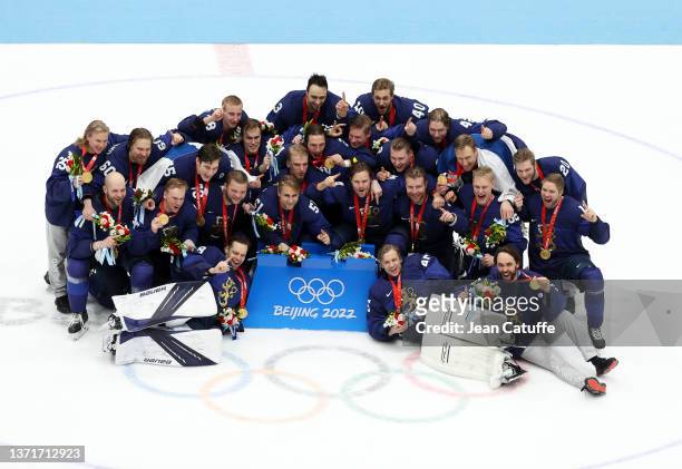 Members of Gold medallist Team Finland pose during the Men's Ice Hockey medal ceremony following the Gold Medal game between Team Finland and Team...