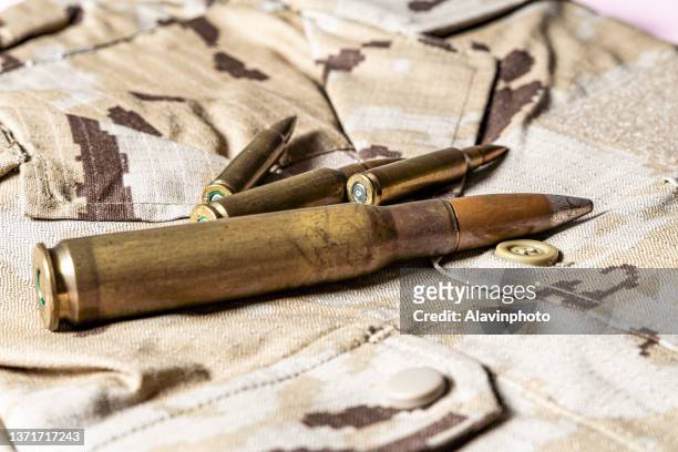 military equipment ammunition and camouflage uniform - leuchtgeschoss stock-fotos und bilder