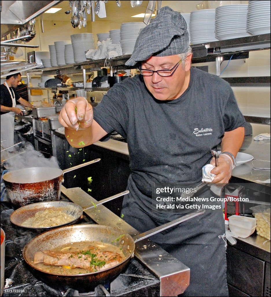 (081007 Somerville, MA) Chef Antonio Veneziano of Salvatore's at 225 Northern Ave. with a dish of veal piccata. Veneziano adds seasonings to the veal. Friday, August 10, 2007. Staff photo by Ted Fitzgerald.