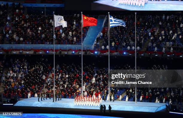 The flags of IOC, China and Greece are seen inside of the Beijing National Stadium during the Beijing 2022 Winter Olympics Closing Ceremony on Day 16...