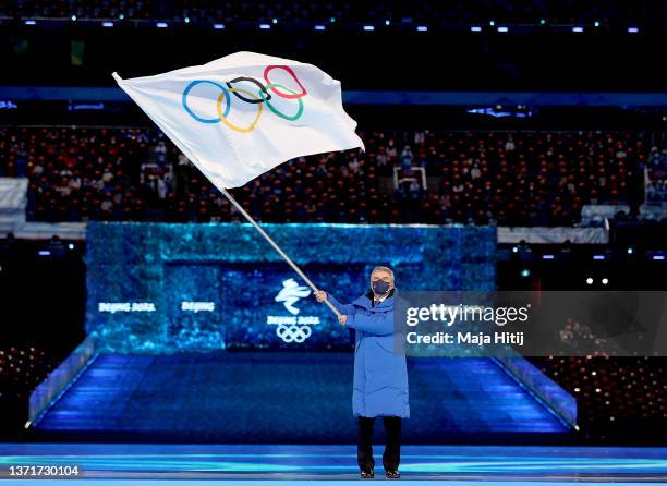 Thomas Bach, IOC President waves the flag of the IOC during the Beijing 2022 Winter Olympics Closing Ceremony on Day 16 of the Beijing 2022 Winter...