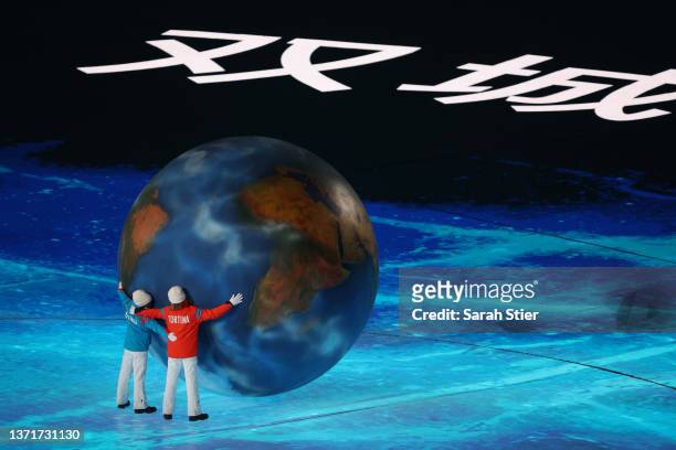 Children representing Milan and Cortina hug a globe as part of the handover ceremony during the Beijing 2022 Winter Olympics Closing Ceremony on Day...