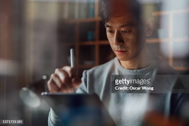 young man working from home with digital tablet - asian architect 40 imagens e fotografias de stock