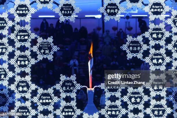 The names of the competing countries are seen alongside the Olympic flame inside of the Beijing National Stadium ahead of the Beijing 2022 Winter...