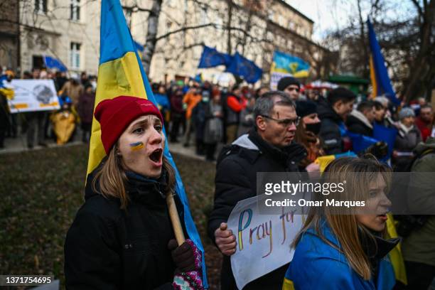 Ukrainians hold banners and Ukrainian national flags during a protest for peace in Ukraine in front of Russia's Consulate on February 20, 2022 in...