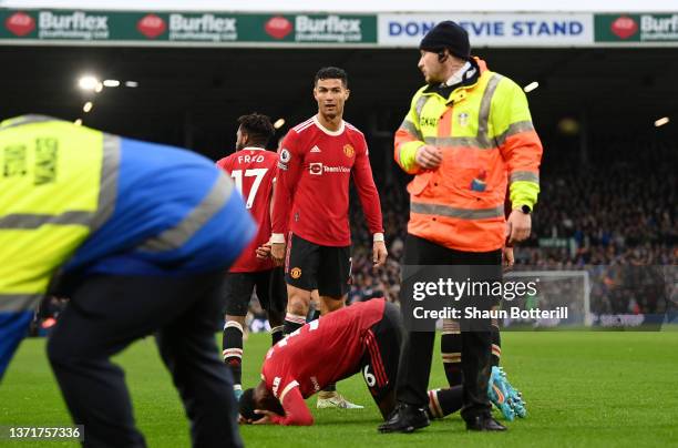 Cristiano Ronaldo looks on as Anthony Elanga of Manchester United is hit by an object from the crowd during the Premier League match between Leeds...