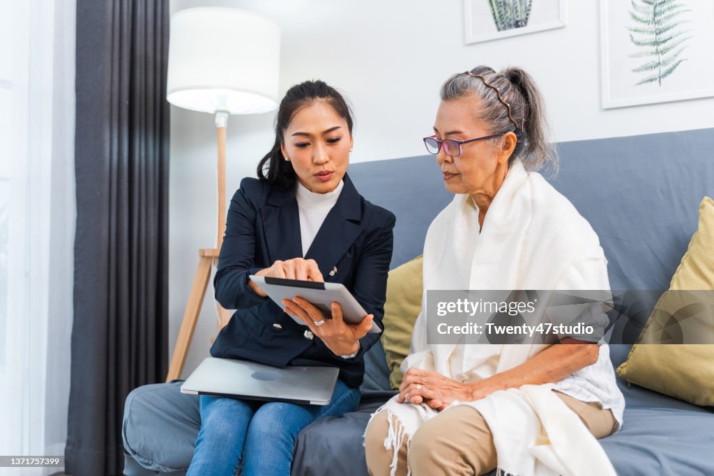 An Insurance consultant visiting senior woman at home