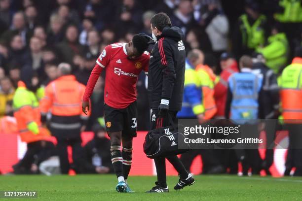 Anthony Elanga of Manchester United receives medical treatment after being hit by an object from the crowd during the Premier League match between...