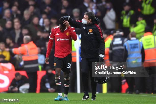 Anthony Elanga of Manchester United receives medical treatment after being hit by an object from the crowd during the Premier League match between...