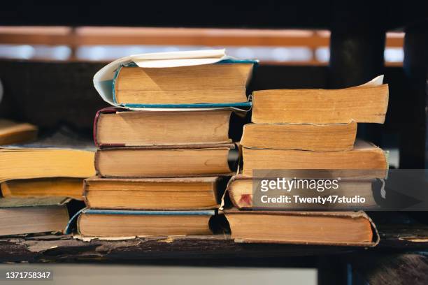 stack of old books on the shelf - libri antichi foto e immagini stock