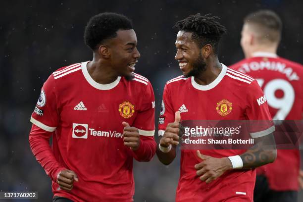 Anthony Elanga of Manchester United celebrates with teammate Fred after scoring their side's fourth goal during the Premier League match between...