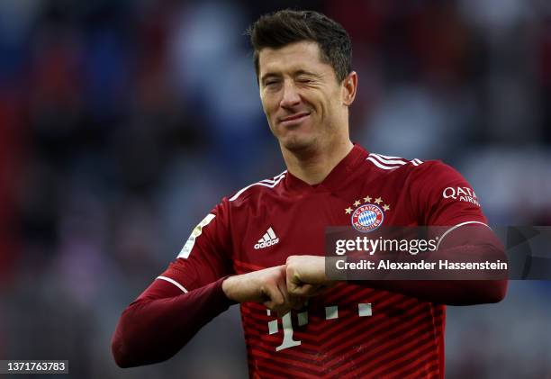 Robert Lewandowski of FC Bayern Muenchen celebrates after scoring their team's third goal during the Bundesliga match between FC Bayern München and...