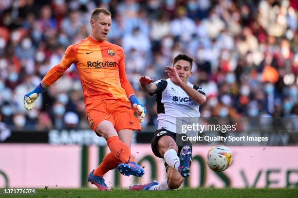 Hugo Duro of Valencia CF competes for the ball with Marc Andre Ter Stegen of FC Barcelona during the La Liga Santander match between Valencia CF and...