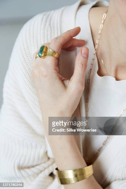 close up of a female hand wearing a golden ring with a gemstone - 48 carats stock pictures, royalty-free photos & images