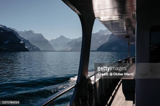 boat sailin on lake lucerne with the alps in switzerland - lake lucerne stock pictures, royalty-free photos & images