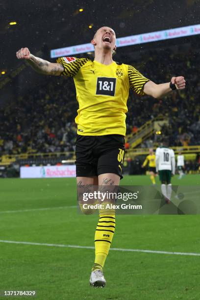 Marius Wolf of Borussia Dortmund celebrates after scoring their team's third goal during the Bundesliga match between Borussia Dortmund and Borussia...