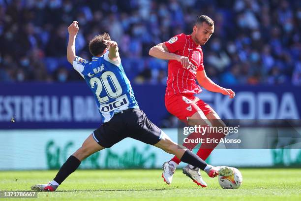 Joan Jordan of Sevilla CF challenges for the ball against Keidi Bare of RCD Espanyol during the LaLiga Santander match between RCD Espanyol and...