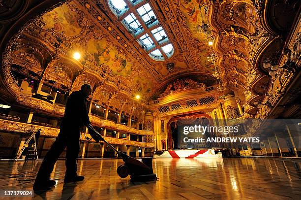 British maintenance engineer Darren Unsworth polishes the wooden floor during the annual cleaning of the ballroom in Blackpool Tower in Blackpool,...
