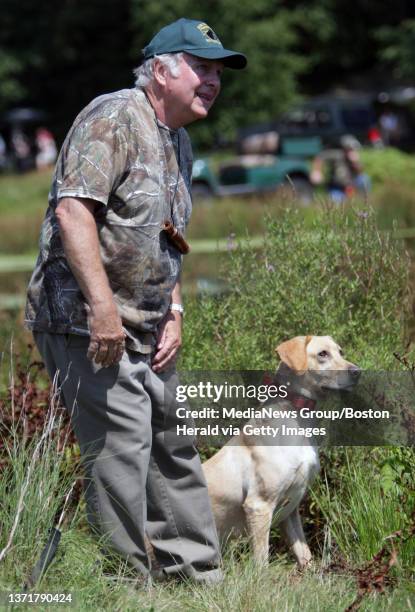 Opening of the nature trail and Cranberry bog behind Bass Pro Shops at Patriot Place. Dog trainer Ron Ober with Winterwood Retrievers works with a...