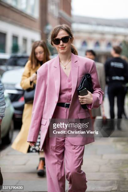 Guest is seen wearing pink suit, black clutch, Prada heels outside Eudon Choi during London Fashion Week February 2022 on February 19, 2022 in...