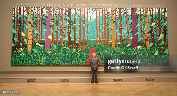 British artist David Hockney poses in front of his painting entitled "The Arrival of Spring in Woldgate, East Yorkshire in 2011 " at the opening of...