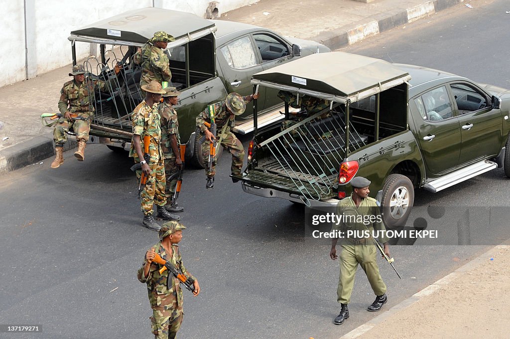 Soldiers carry metal barricade used by p