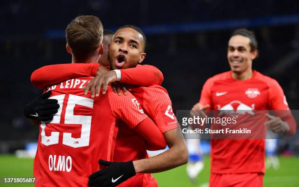 Christopher Nkunku of RB Leipzig celebrates with teammates after scoring their team's third goal during the Bundesliga match between Hertha BSC and...