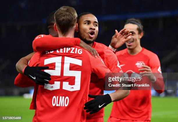 Christopher Nkunku of RB Leipzig celebrates with teammates after scoring their team's third goal during the Bundesliga match between Hertha BSC and...