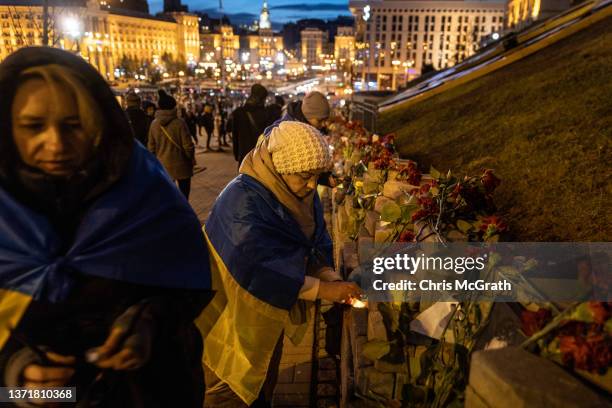People light candles while visiting a memorial dedicated to late Euromaidan activists along the Alley of the Heavenly Hundred Heroes during Maidan...