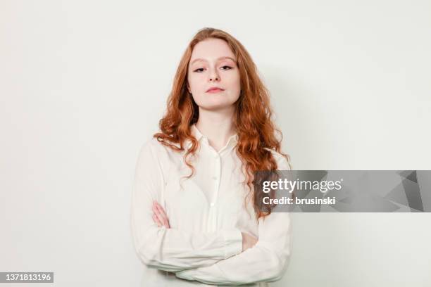 studio portrait of an attractive 20 year old red haired woman - arms crossed stock pictures, royalty-free photos & images