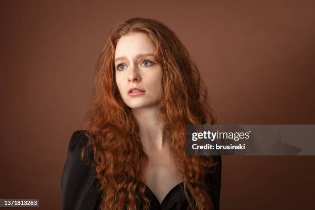 studio portrait of an attractive 20 year old red haired woman - year long stock pictures, royalty-free photos & images