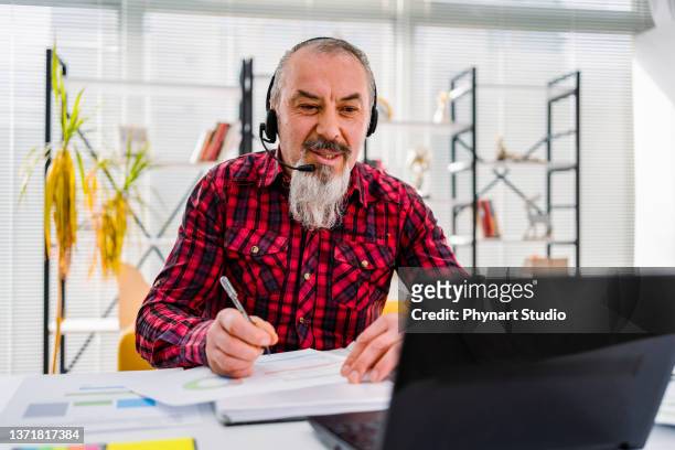 man wear headset watching webinar video course - gifted movie stock pictures, royalty-free photos & images